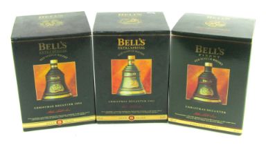 Three Bell's whisky Christmas decanters, for Christmas 1993, 1994 and 1995, boxed.