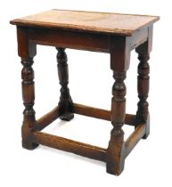 An 18thC style oak joint stool, with turned legs united by plain stretchers, 44cm high, the top 41cm