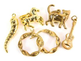 A pair of 9ct gold twist hoop earrings, and a selection of unmarked yellow metal charms, to include