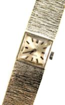 An Omega ladies wristwatch, with a square silvered coloured dial, on bark effect bracelet, white met