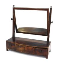 A George III mahogany toilet mirror, the bow fronted base with three fitted drawers with boxwood str