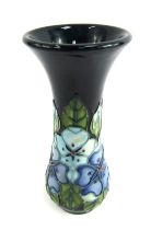 A Moorcroft stem vase, on a blue ground, decorated in the Cobridge Cobalt Blue pattern, stamped to u