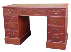 A reproduction mahogany twin pedestal desk, with green leather inset top above arrangement of