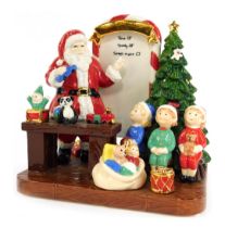 A Royal Doulton porcelain figure group from The Holiday Traditions Collection, modelled as Santa's T