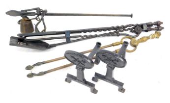 A pair of blackened fire irons, 16cm wide, a set of three fire implements, and a pair of brass tongs