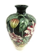 A Moorcroft squat vase, on a green and cream ground, in the Cottage pattern, indistinctly signed in