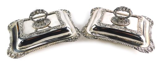 A pair of silver plated tureens, each of rectangular form with an out swept fluted scroll and shell