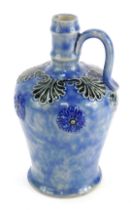 A Royal Doulton stoneware flagon, with raised floral and leaf decoration against a mottled blue grou