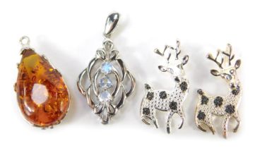 Four TJC pendants, comprising two black diamond deer, white metal stamped 925, a Baltic amber pendan