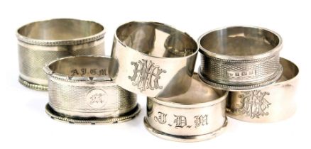 Six silver napkin rings, to include three with engine turned design, some bearing initials, Edward V