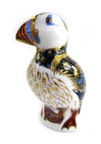 A Royal Crown Derby porcelain paperweight modelled as a puffin, silver stopper and red printed marks