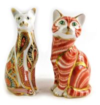 A Royal Crown Derby porcelain paperweight modelled as Siamese Cat, second, silver stopper and red pr