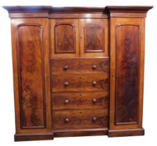 A Victorian figured mahogany inverted breakfront wardrobe, with a moulded cornice above two panelled