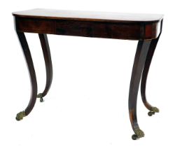 A Regency mahogany D shaped side table, with a panelled frieze on sabre legs with brass claw feet an