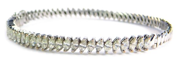 A diamond hinged bangle, set with thirty marquise shaped diamonds, each claw set approx 0.05cts, on
