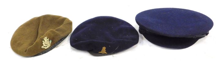 Three British military hats, comprising two Kangol berets and a navy officers cap with Artillery cap