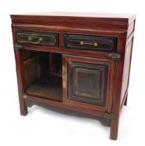 A late 19thC Chinese elm side cabinet, with two frieze drawers above two panelled doors, on stiles,