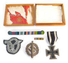 An Iron Cross dated 1914, shoulder badge, steel uniform badge, and medal bar.