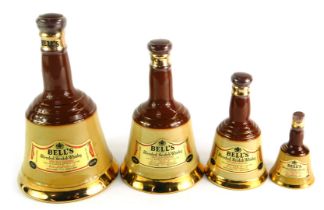 A graduated set of four Bell's Scotch whisky decanters.