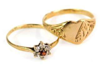 Two 9ct gold dress rings, comprising a stone set cluster with cz and rubies, and a signet ring with