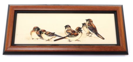 A Moorcroft pottery wall plaque, depicting seven birds against a cream ground, impressed marks to un