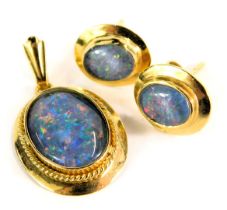 An opal set pendant and earring set, the blue and white backed imitation opal, in a yellow metal fra