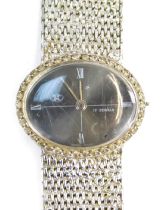 A JNF lady's fashion watch, the oval dial with silvered finish and four point Roman numerals, with s