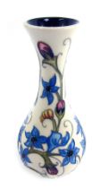 A Moorcroft Emma Bossons True Blue Moorcroft bud vase, on a cream ground, stamped 2012, 16cm high.
