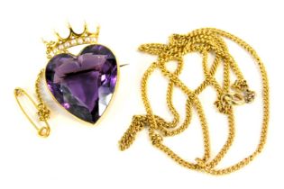 An amethyst heart shaped brooch, the faceted amethyst in a rub over yellow metal setting, on single