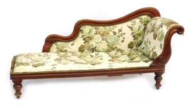 A Victorian mahogany framed chaise longue, upholstered in floral fabric, 182cm wide.