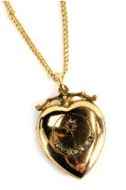 An Edwardian heart shaped locket, set with red and white paste stones, in a rolled gold setting, 3cm