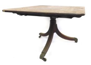 An early 19thC mahogany tilt top dining table, with a rectangular top on tapered columns and reeded