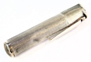 A Colibri cigarette lighter, of engine turned decoration formed as a pen case, white metal stamped s