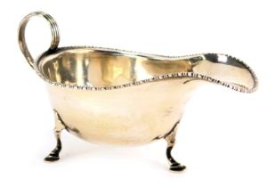 A George V silver sauce boat, with beaded border, on tripod capped feet, Birmingham 1928, 3.67oz.