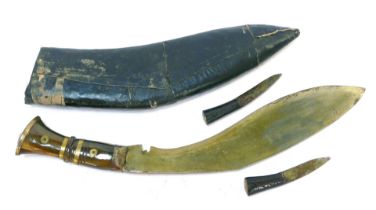 A Kukri knife, with a horn grip, with two additional knives, in leather scabbard, 44cm wide.