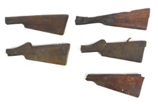 Five antique wooden gun stocks.