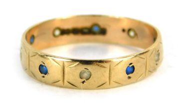 A sapphire and diamond eternity ring, set with round brilliant cut sapphire and diamonds, yellow met