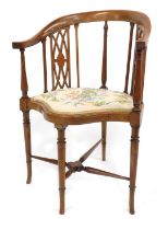 An Edwardian inlaid mahogany open tub chair, with shield shaped seat, on slender turned legs.