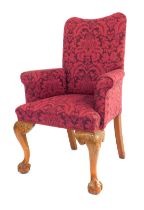 An 18thC style upholstered arm chair, with carved cabriole legs and ball and claw feet, with plum fl