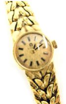 An Omega ladies wristwatch, the bark effect three row V splayed bracelet yellow metal stamped 750, w