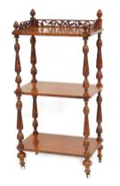 A Victorian walnut three tier whatnot, with pierced gallery to the top and with turned column suppor