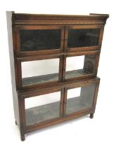 A 1920s oak sectional bookcase by Minty Limited of Oxford, with three glazed compartments, with step