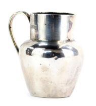 An Edward VII Mappin and Webb silver cream jug, of plain design, London 1907.