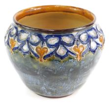 A Royal Doulton stoneware jardiniere, decorated with a blue and amber toned lappet border against a