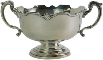 A George V silver two handled pedestal bowl, with shaped rim and cast shell decoration, on a stepped