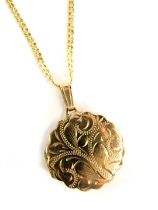 A 9ct gold locket pendant and chain, the circular locket with petalated border and engraved floral d