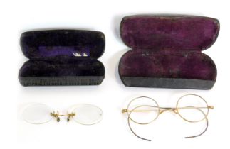 Two pairs of gilt framed spectacles, each in leather carry case.