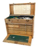 A Neslein oak portable tool chest, fitted with numerous shallow drawers and detachable front cover,