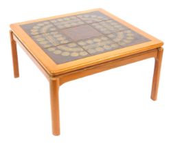 A 1970s square tiled topped teak coffee table, with treacle glazed brown tiles, on rounded square le