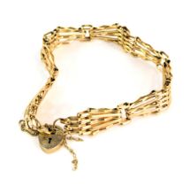 A 9ct gold gate bracelet, of five bar fan design, with safety chain and small heart shaped padlock,